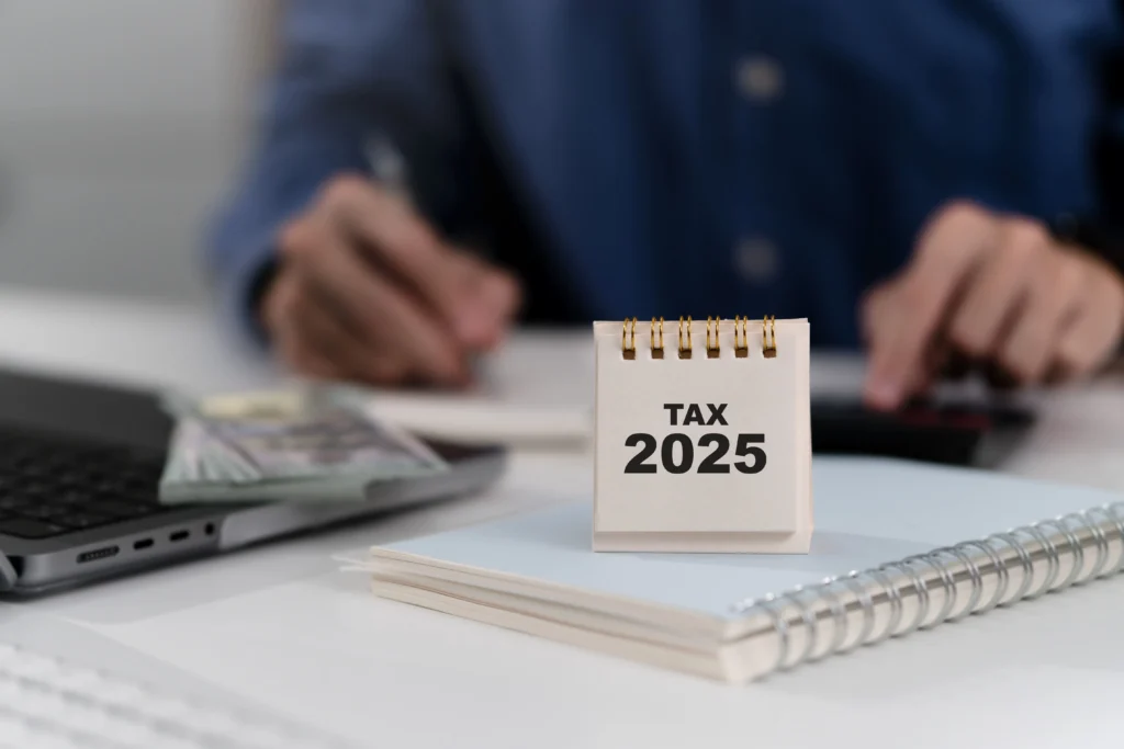 CPA reviewing effective tax strategies and 2025 tax law changes with small business client.